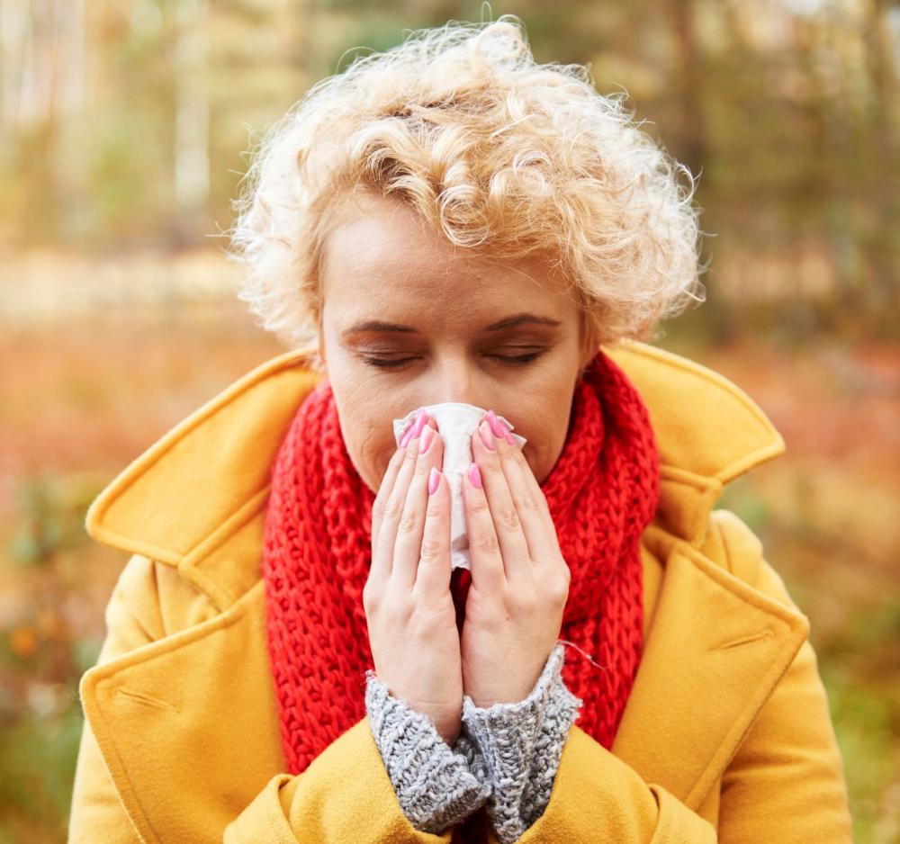 une femme allergique se mouche le nez